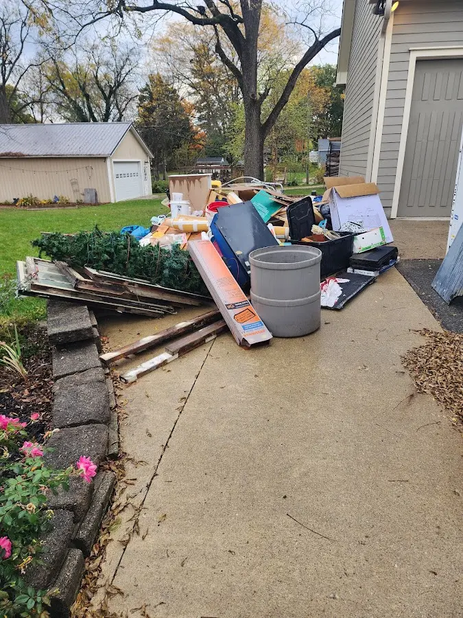 Dumpster being loaded with debris for Estate Cleanout Dumpster Rental in Meadow Lake
